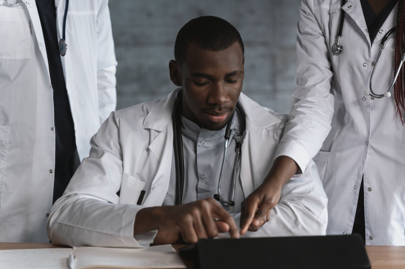 Physicians reviewing information together on a tablet